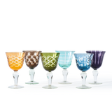 Set of six colorful glass goblets on a white background